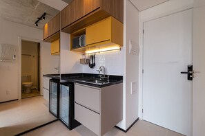 Fridge, microwave, coffee/tea maker, cookware/dishes/utensils