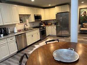 Enjoy cooking and dining in this well-equipped kitchen with a dining table and comfortable seating.