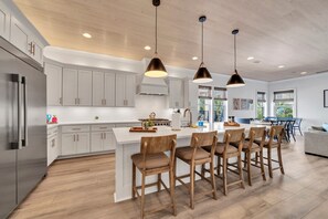 Enjoy cooking and socializing in this well-equipped kitchen with a large island and stainless steel appliances.