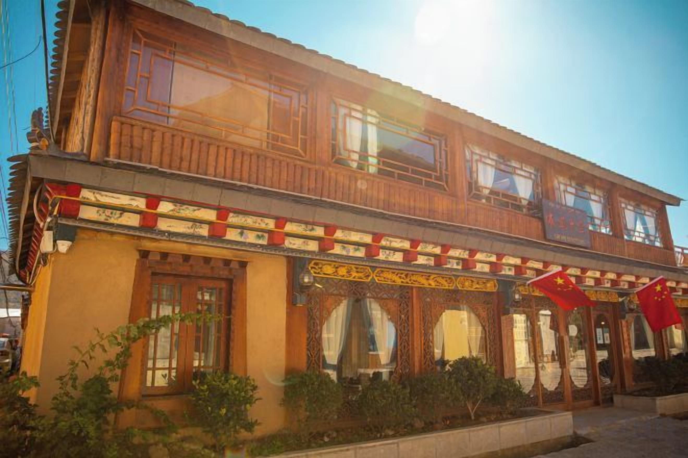 A two-story building with traditional wooden architecture, multiple windows, and a decorative facade.