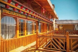 A traditional wooden building with balconies and large windows. - Spring Breeze Inn (Shangri-La)