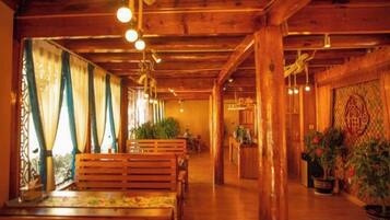 A wooden interior with benches and potted plants.