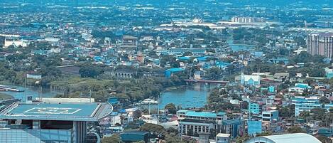 A cityscape with a mix of modern and traditional buildings, a river, and a bridge.