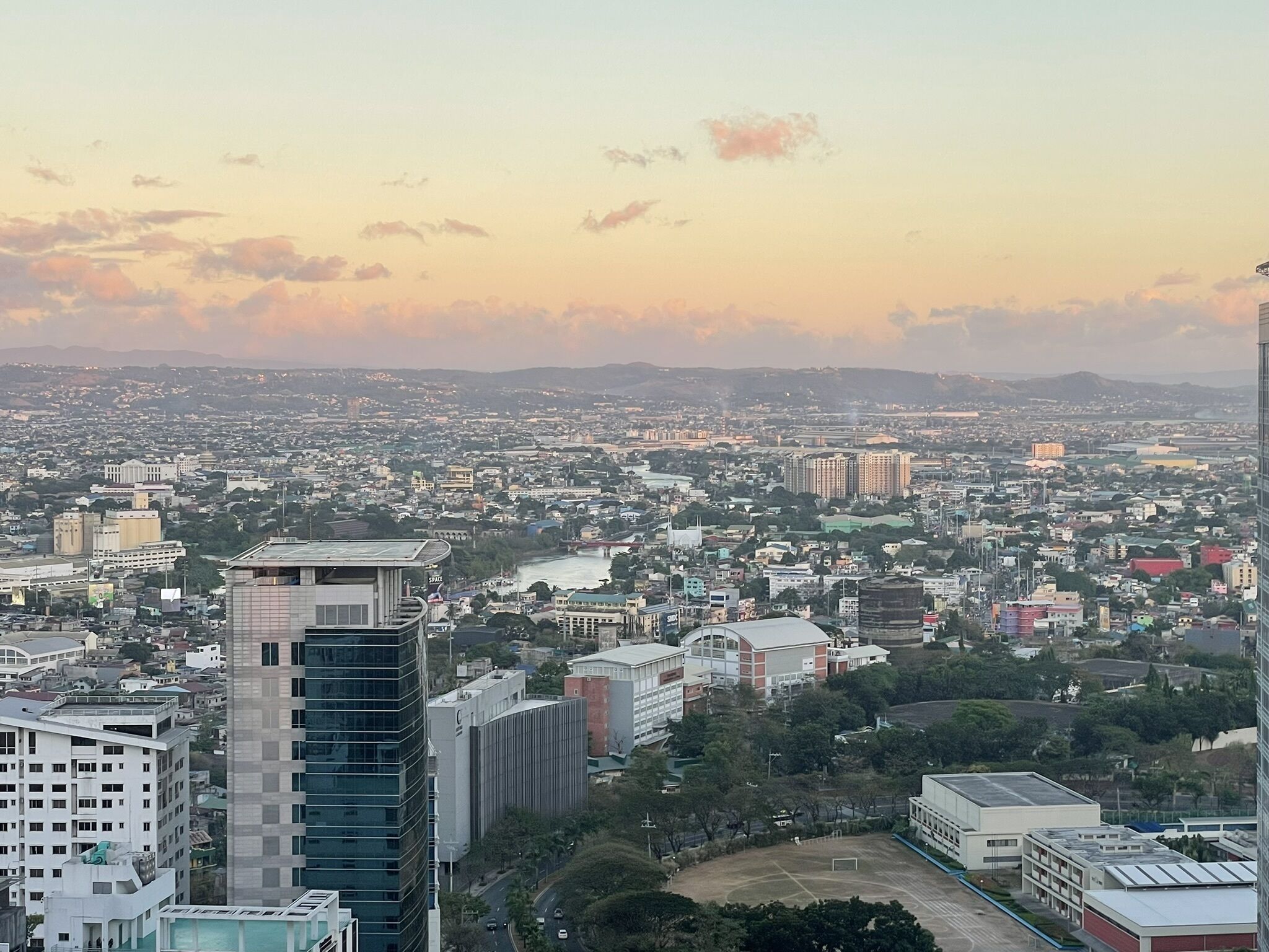 A cityscape with a variety of buildings, including high-rise structures and smaller residential buildings.