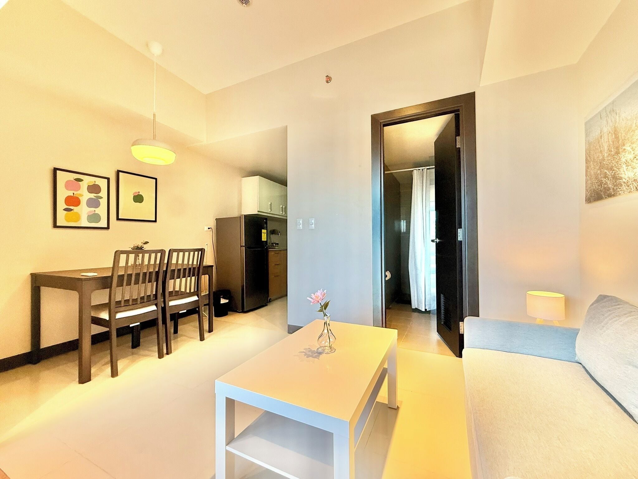 Un espace de vie compact comprenant un coin repas, une kitchenette et un canapé.