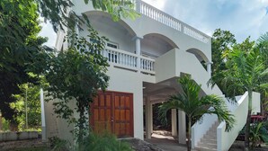 A two-story building with a balcony and a staircase leading to the upper level.