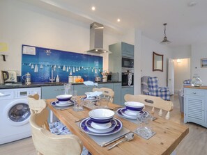 A modern kitchen with a dining area set for six.