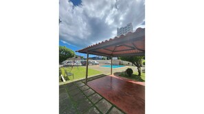 A covered outdoor area with a pool, a swing set, and a carport. - Quiet and cozy apartment: 2 bedrooms 2 bathrooms and balcony.  (Panamá)