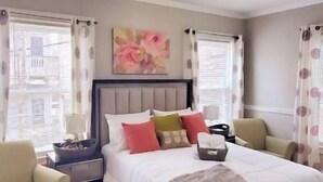 A bedroom with a bed, nightstands, a chair, and a rug. - Centrally located in the heart of Boston near T (Boston)