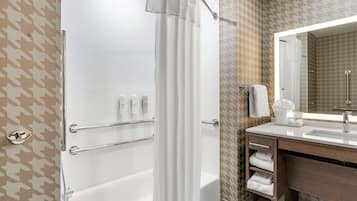 A modern bathroom with a shower, toilet, and vanity.