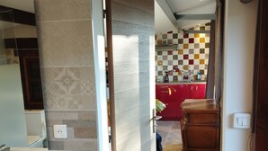 A modern kitchen with a checkered backsplash and red cabinets. - Chalet Avec vue Magnifique sur les Montagnes Basques, à 3 Minutes Despelette (Itxassou)