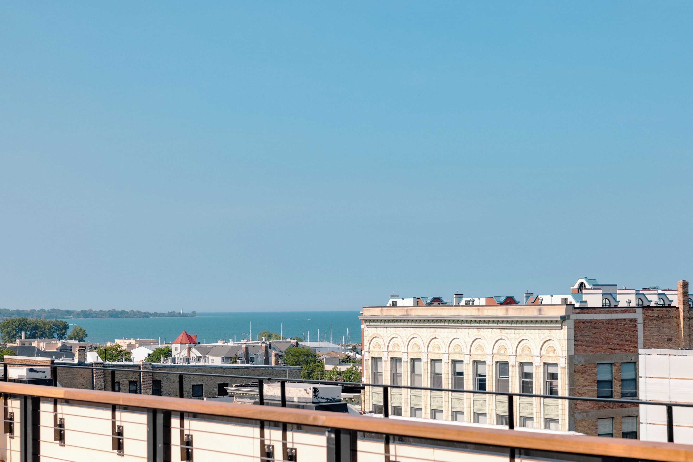 A cityscape with buildings and a view of the sea.