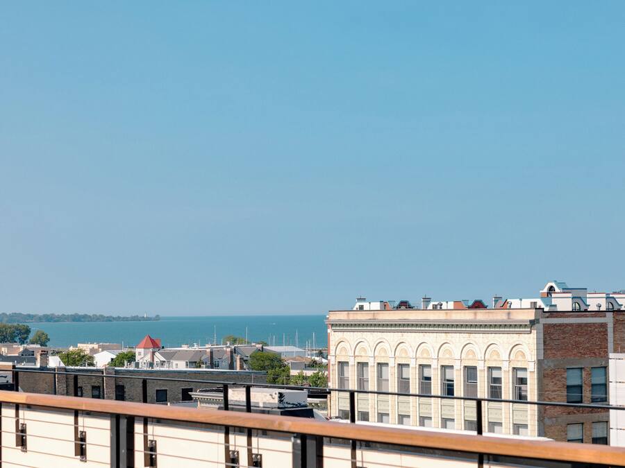 A cityscape with buildings and a view of the sea.