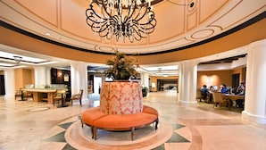 A spacious lobby with a central seating area, a chandelier, and a pool table. - Beautiful Waterfront Condo in the Luxurious Four Star Hotel-7th Floor (Myrtle Beach)