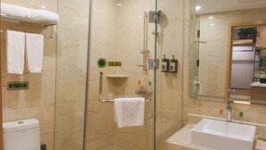 A modern bathroom with a glass-enclosed shower, a white sink, and a toilet. - Vienna Hotel (Rugao)