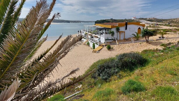 A coastal building with a beach view, a patio area, and a small garden. - 2 bedrooms beachfront (Vila Nova de Milfontes)