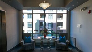 A lobby with two armchairs, a small table, and a potted plant. - 7301 E. 3rd Avenue / UNIT #208 (Scottsdale)