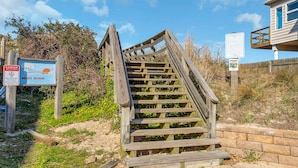 A wooden staircase leading to a beach access area with warning signs and a lookout point. - 1 Block to Beach • Hot Tub • Fire Pit • Game Room (Norfolk)