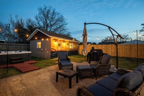 A backyard with a hot tub, outdoor seating, and string lights. - 1 Block to Beach • Hot Tub • Fire Pit • Game Room (Norfolk)