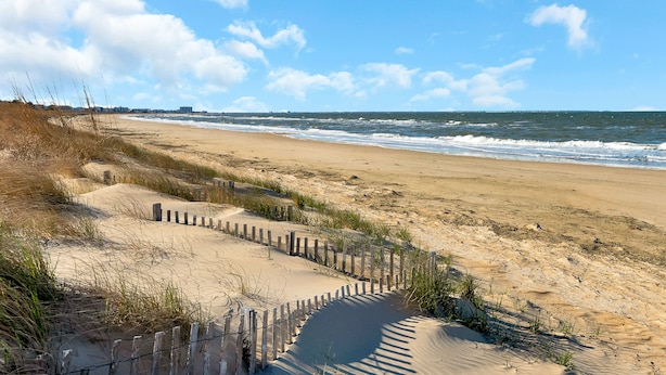 A sandy beach with a wooden fence and dunes. - 1 Block to Beach • Hot Tub • Fire Pit • Game Room (Norfolk)