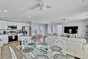 A modern kitchen with white cabinets, a built-in microwave, and a stainless steel oven.