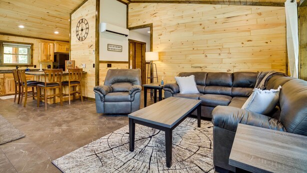A cozy living room with a sectional sofa, a coffee table, and a dining area with a wooden table and chairs. - Near Memorial Park: Lake Arbutus Vacation Rental (Hatfield)