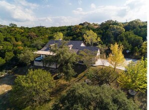 A house surrounded by dense trees and a clear sky. - Outdoor Living at Its Finest - Group Spa, Fire Gathering, Star Dining (Jonestown)