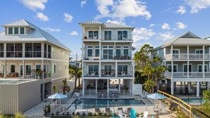 A multi-story beachfront house with a swimming pool, outdoor seating, and a well-maintained lawn. - Tides Beach House: Beachfront New Build- Sleeps 30, Pet Friendly, Priv. Pool (Cape San Blas)