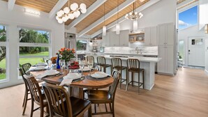 A spacious kitchen with a large island, wooden ceiling beams, and modern pendant lighting. - AC IN ALL 4 BEDROOMS! Recently renovated 4BD/3B Queen's Bath home w/Jacuzzi! (Princeville)