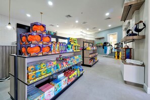 Een winkel met schappen vol speelgoed en sportartikelen, waaronder basketbal en opblaasbare ballen.