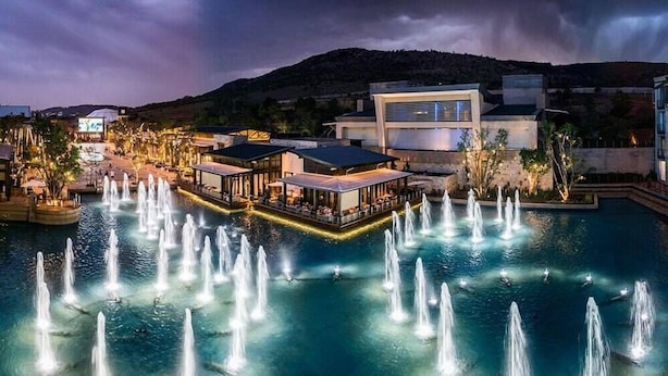 A waterfront hotel with multiple dining areas and a pool with fountains. - Southern Sun Silverstar (Krugersdorp)