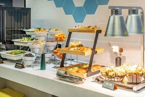 A buffet with various food items and a sign indicating the price. - Elegant Stay Hotel (Shantou Jinhul Road Store) (Shantou)
