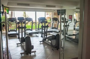 A gym with treadmills, elliptical machines, and weight benches. - D-View & Relax Overlooking the Ocean (Puerto Vallarta)