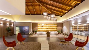 A spacious lobby with a high ceiling, modern furniture, and a central seating area. - Ondas Praia Resort by WAM Experience (Porto Seguro)