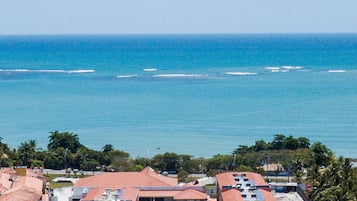 A coastal hotel with multiple buildings, a swimming pool, and ocean views.