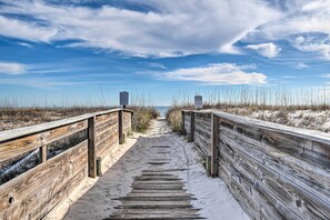 A wooden boardwalk leading to a beach with a sign indicating a nature reserve. - Pool Access & Steps to Beach: Coastal Getaway! (Gulf Shores)