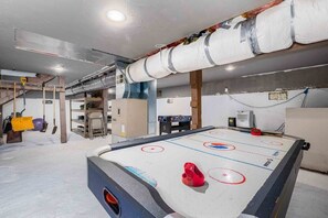 An indoor ice hockey rink with a pool table and exercise equipment. - Close to Ski + Snowboard | Games | Hiking Trails (Snoqualmie Pass)