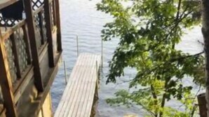 A wooden staircase leading to a dock over water. - Amazing Views! 2 BR 8-person Condo Lake Tomahawk/Minocqua Chain, Dock included (Lake Tomahawk)