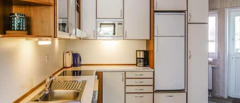 Fridge, stovetop, dishwasher, coffee/tea maker