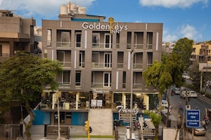 A multi-story building with a sign for 'Goldenkeys Inn' and a salon named 'Friendly Salon' on the ground floor. - Goldenkeys Inn (New Delhi)