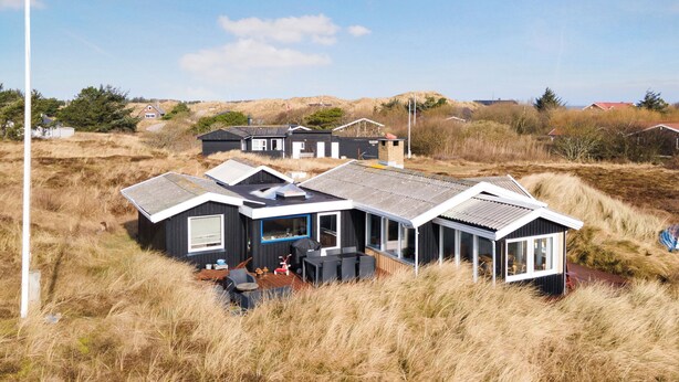A modern house with a large deck, surrounded by tall grass. - Holiday idyll between fjord and sea (Hvide Sande)