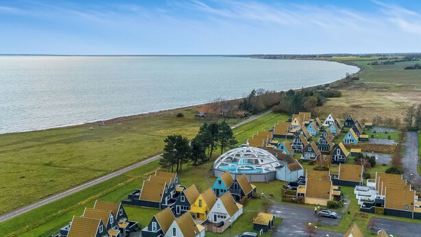 A coastal village with houses, a large body of water, and a distinctive building with a dome. - Family holiday with sea view in Gedser Feriepark (Gedser)