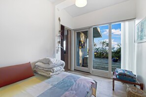 A bedroom with a bed, a window, a door, and a view of the outdoors. - Cottage on Fur island with exceptional sea view (Fur)
