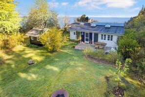 A house with a deck, a small shed, and a view of the sea. - Cottage on Fur island with exceptional sea view (Fur)