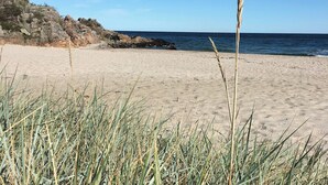 A beach with sand, grass, and rocky cliffs. - Stunning home in Unknown with 3 Bedrooms and WiFi (Allinge)