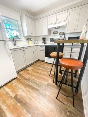 Enjoy cooking in this well-equipped kitchen with a coffee maker and toaster, and dine at the counter with two stools.