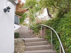 A staircase with metal railings leading to a building with a white exterior wall. - Holiday Apartment "Am Eiberg" with Mountain View, Private Terrace & Wi-Fi (Bad Wildbad)