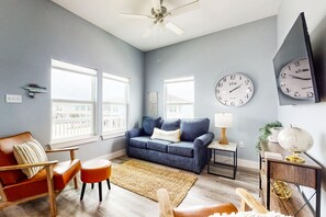 Relax in this stylish living room with a sofa, armchair, and coffee table.
