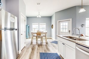 Enjoy cooking in this well-equipped kitchen with a central island, double sink, and dining area.