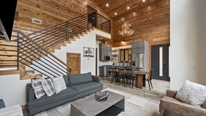 A modern interior with a staircase, a dining area, and a kitchen.